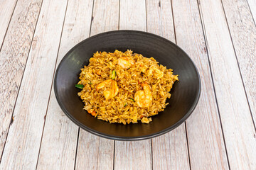 Singapore fried rice is an Indochinese street food and popular dish. The rice is sautéed with shrimp and meats such as pork and chicken and flavored with spices such as curry powder.