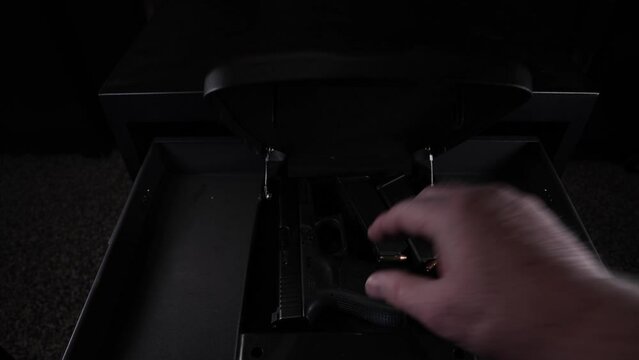 Man uses his fingerprint to open a biometric safe and then puts a full magazine in a semi-automatic handgun