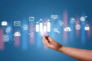 Hand pointing a growing virtual hologram stock with business icons. Stock market. Growth, progress, success, cloud, mail, contacts, global security. Internet of things.