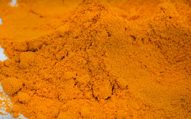 ground Turmeric powder heap with selective focus, full frame