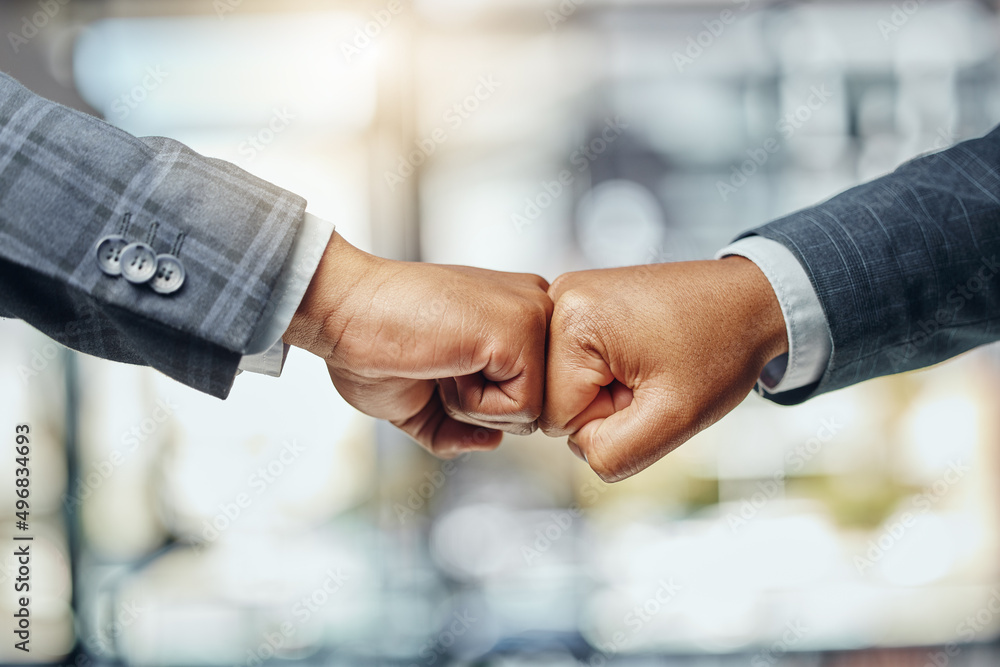 Poster I support you every step of the way. Shot of two unrecognizable lawyers giving each other a fist bump at work.
