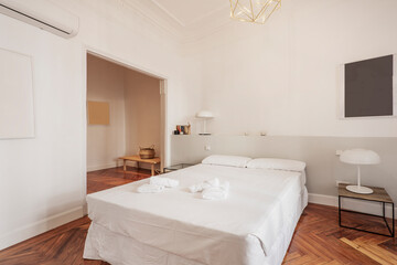 Fototapeta na wymiar bedroom with double bed, white pillows, dresser in the background, white bedside tables and bedding, gray masonry headboard and reddish wood floors