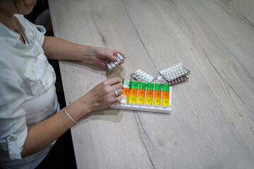 young woman preparing medication at homeat the table