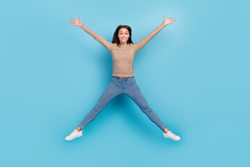 Fototapeta na wymiar Full length body size view of attractive cheerful girl jumping having fun isolated over bright blue color background