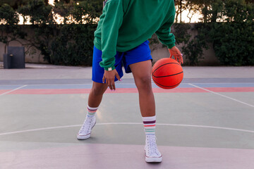 legs of a woman playing on a basketball court