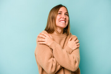 Young caucasian woman isolated on blue background laughing and having fun.