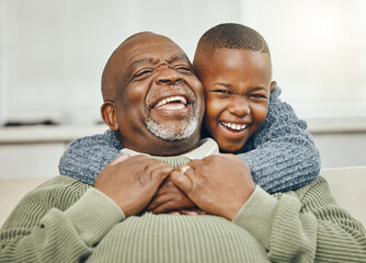 My boy, from my boy. Shot of a grandfather bonding with his young grandson on a sofa at home.