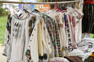 Romanian traditional costumes exhibited at a tourism fair. handmade costumes. details.