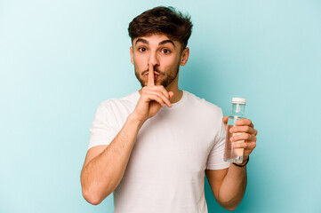 Young hispanic man holding a bottle of water isolated on white background keeping a secret or asking for silence.