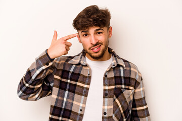 Fototapeta premium Young hispanic man isolated on white background showing a disappointment gesture with forefinger.