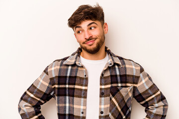 Young hispanic man isolated on white background confused, feels doubtful and unsure.