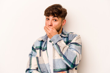 Young hispanic man isolated on white background scared and afraid.