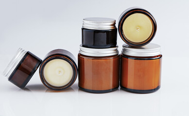 A set of different aroma candles in glass jars on a white background. Scented handmade candle. Soy,...