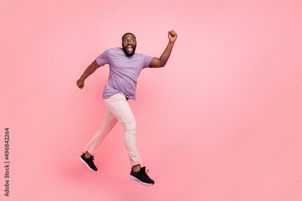 Poster full length body size view of attractive cheerful active guy jumping running going isolated over pin
