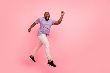 Fototapeta na wymiar Full length body size view of attractive cheerful active guy jumping running going isolated over pink pastel color background