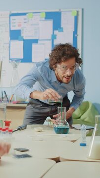 Portrait of a Chemistry Teacher Mixing Chemicals in the Beakers. Video Footage with Vertical Screen Orientation 9:19