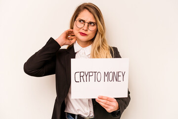 Young business caucasian woman holding a crypto money placard isolated on white background touching back of head, thinking and making a choice.