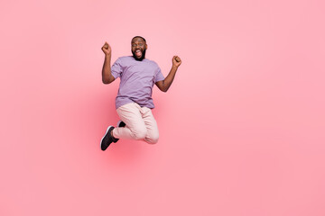 Fototapeta na wymiar Full length body size view of attractive cheerful lucky guy jumping having fun isolated over pink pastel color background