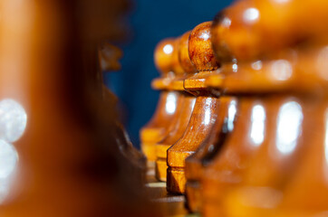 White chess pieces stand in a row. Close up to the white chess pieces. A game of chess