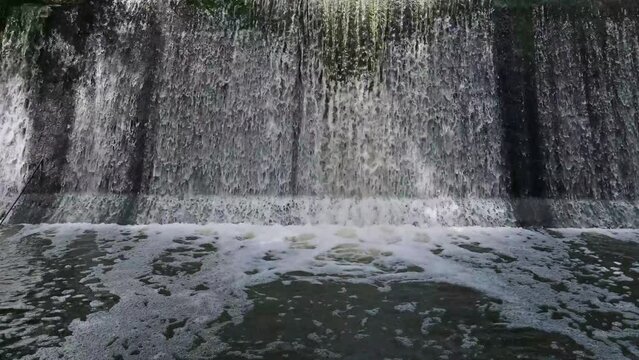 Artificial shaded waterfall on dam on Hirskyi Tikych river, Buky Canyon, Cherkasy Region, Ukraine.

