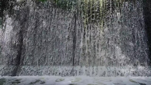 Artificial shaded waterfall on dam on Hirskyi Tikych river, Buky Canyon, Cherkasy Region, Ukraine.
