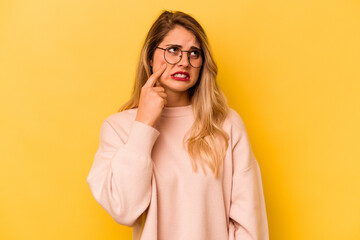 Young caucasian woman isolated on yellow background crying, unhappy with something, agony and confusion concept.