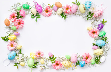 Naklejka na ściany i meble Spring Easter background with multicolored eggs and spring flowers. Top view flat lay background . Greeting card pattern with copy space.
