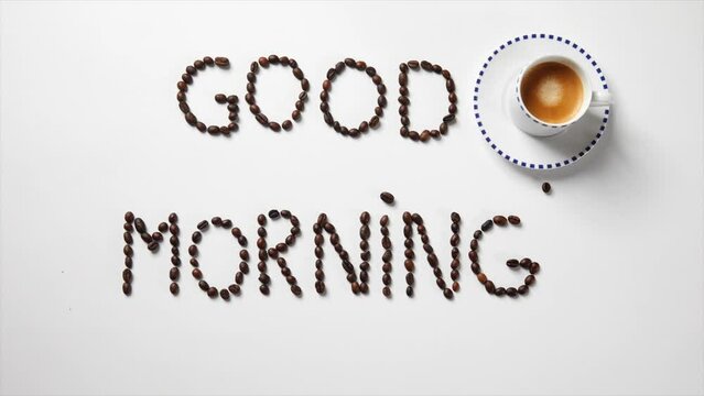 Stop motion with the letters "good morning" written with coffee beans and a cup of coffee
