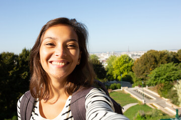 Close up beautiful young woman smiling and taking selfie on vacation