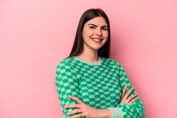 Fototapeta premium Young caucasian woman isolated on pink background who feels confident, crossing arms with determination.