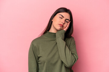 Fototapeta premium Young caucasian woman isolated on pink background who is bored, fatigued and need a relax day.