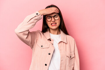 Young caucasian woman isolated on pink background touching temples and having headache.
