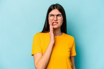Fototapeta premium Young caucasian woman isolated on blue background having a strong teeth pain, molar ache.