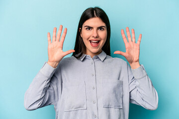 Young caucasian woman isolated on blue background receiving a pleasant surprise, excited and...