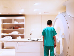 doctor checking mri scanner before scan patient in hospital.
