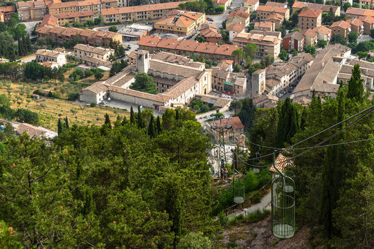 Aerial view of a Cable car climbing the Mont Igino on buildings and trees in Gubbio, Umbria, Italy