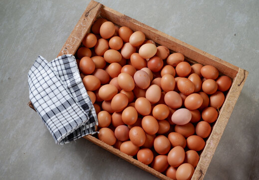 Top view of fresh eggs in a wooden box