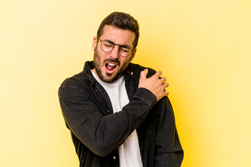 Young caucasian man isolated on yellow background having a shoulder pain.