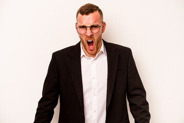Young business caucasian man isolated on white background screaming very angry and aggressive.