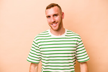 Young caucasian man isolated on beige background happy, smiling and cheerful.