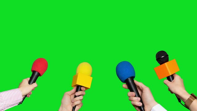 Microphones in the hands of journalists for interview on green screen background. Conference meeting microphones prepared for talker isolated on chroma key background