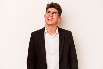 Young caucasian business man isolated on white background dreaming of achieving goals and purposes