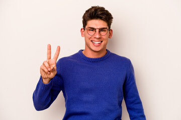 Fototapeta premium Young caucasian man isolated on white background showing number two with fingers.