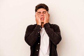 Young caucasian man isolated on white background whining and crying disconsolately.