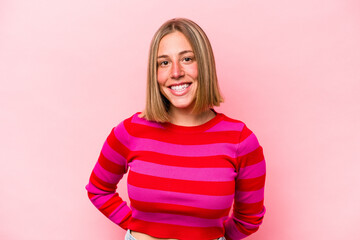 Young caucasian woman isolated on pink background happy, smiling and cheerful.