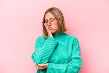 Young caucasian woman isolated on pink background who is bored, fatigued and need a relax day.