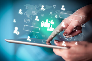 Close-up of a hand using tablet, social media concept