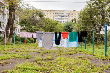 Laundry dries on the rope in courtyard of Khrushchyovka. Khrushchyovka is common type of old low-cost apartment building in Russia and post-Soviet space. Household concept. Russia, Vladivostok.