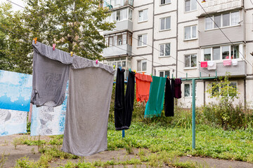 Laundry dries on the rope in courtyard of Khrushchyovka. Khrushchyovka is common type of old low-cost apartment building in Russia and post-Soviet space. Household concept. Russia, Vladivostok.