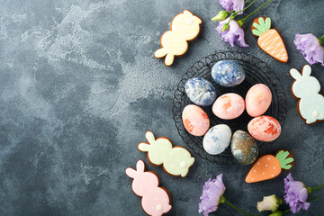 Fototapeta na wymiar Easter eggs. Dyed Easter eggs with marble stone effect ref and blue color in rustic style on dark stone background. Easter background. Top view.